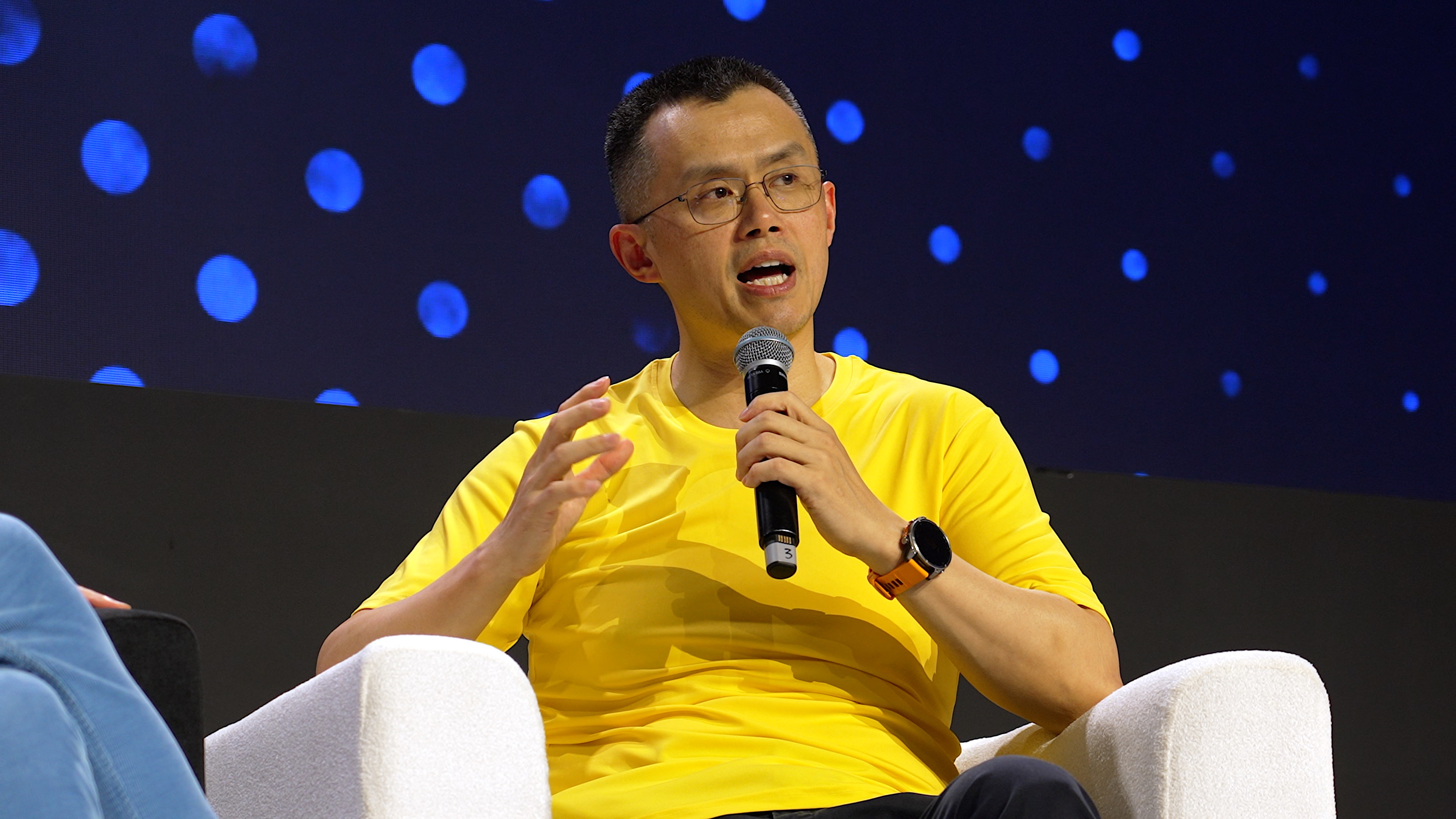 Speaker in a yellow shirt on stage