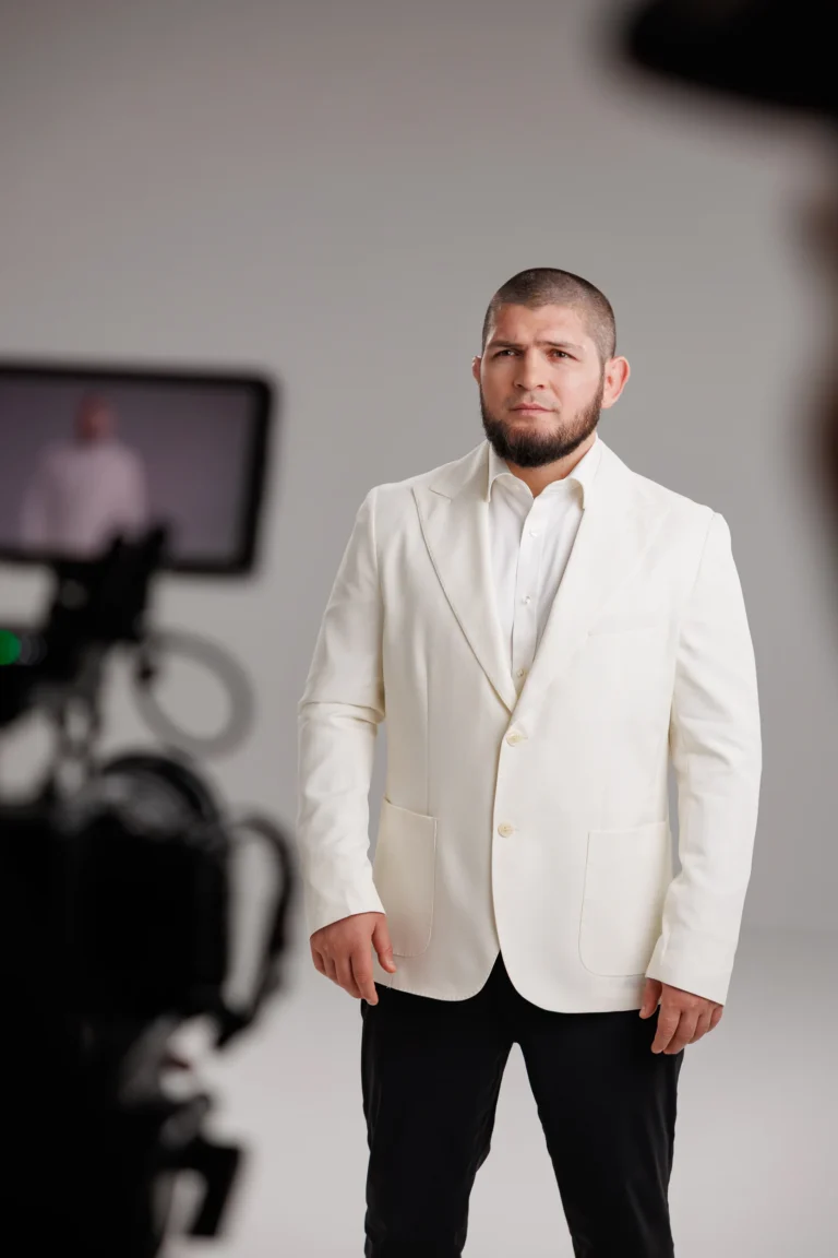 Khabib Nurmagomedov in a white suit during an interview